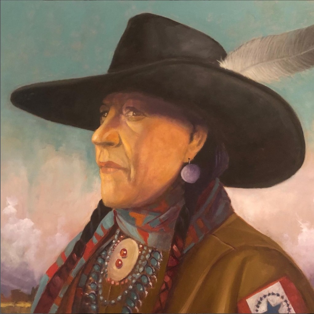 A portrait of a Native American woman wearing a large black hat adorned with a feather, with long braids and traditional jewelry, set against a softly colored background.
