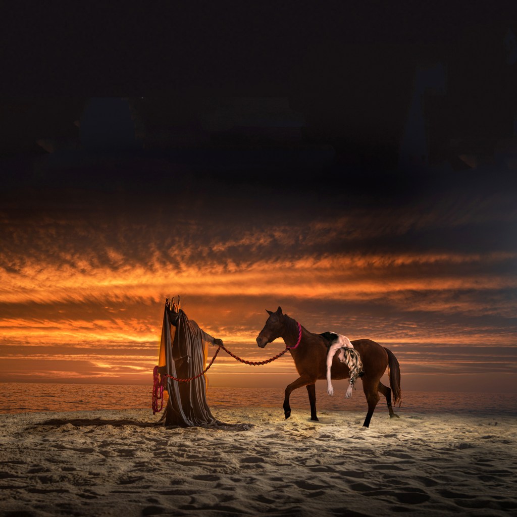 A cloaked figure holds a rope attached to a horse on a beach at sunset, with dramatic clouds and ocean waves in the background.