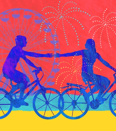 Silhouettes of two people reaching out to each other while riding bicycles against a colorful background featuring a ferris wheel and fireworks.